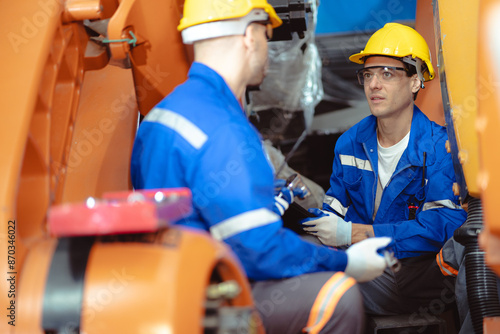 Industrial engineer inspecting mechanic part of robot structure frame in automation factory. Professional robotic and electronic technician working in manufacturing with futuristic innovation machine.