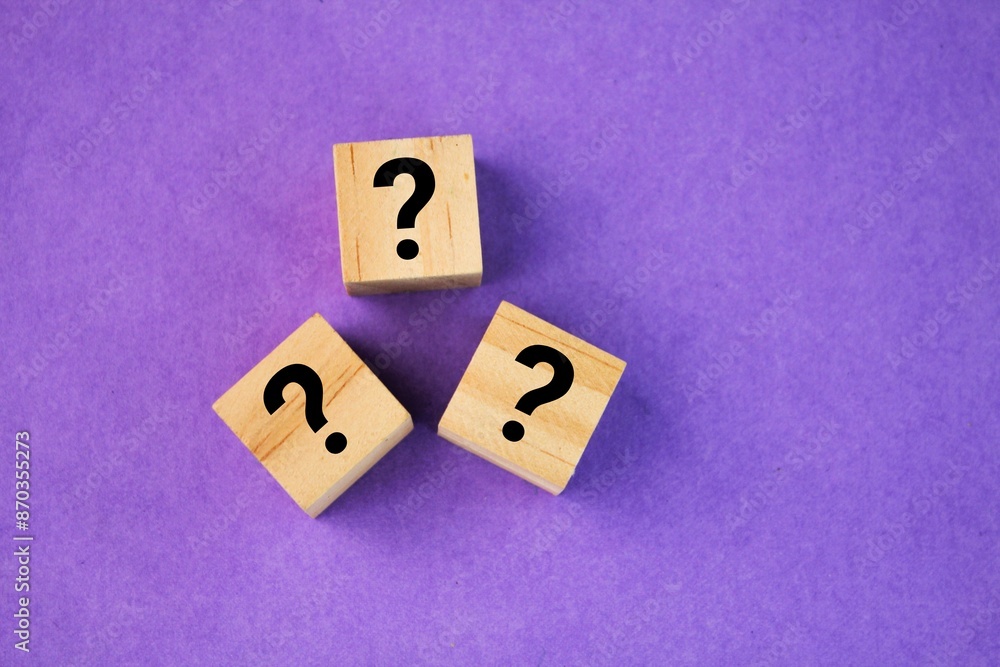 wooden square with three question marks. the concept of question or HR wooden square with three question marks. the concept of question or HR