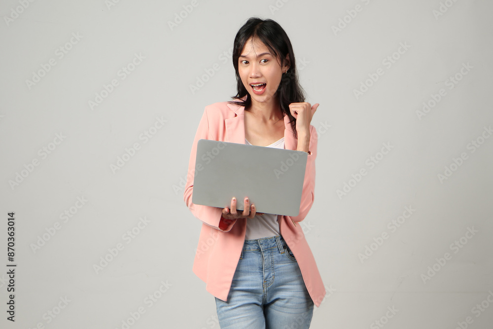 happy asian woman wearing formal casual outfit holding laptop computer on isolated background happy asian woman wearing formal casual outfit holding laptop computer on isolated background