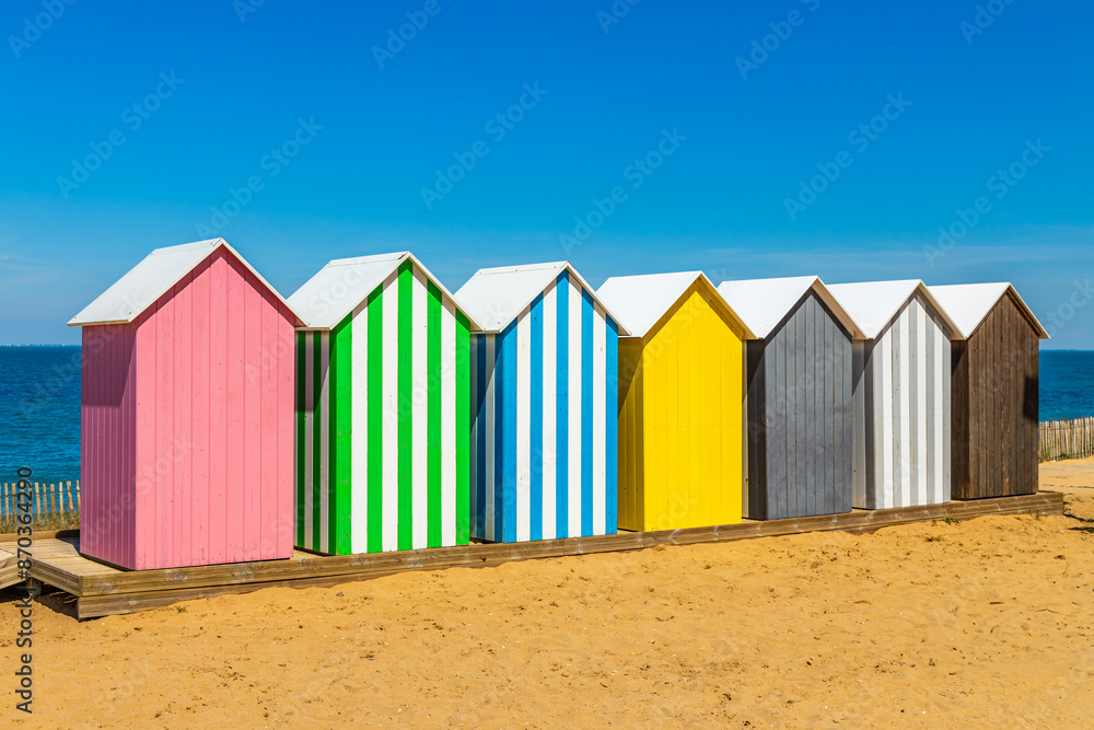 Naklejka premium Multicolored bathing cabins of the beach of La Bree-les-Bains, France on a summer day