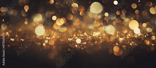Dark gold and black vintage lights with glitter creating a defocused background, ideal for a copy space image. photo
