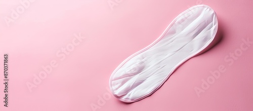 A soft white women's pad on a pink background; ideal for a women's or feminist blog or ad with copy space image.