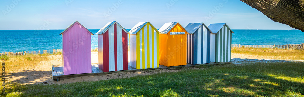 Naklejka premium Panoramic view of colored wooden beach huts of the beach of La Bree-les-Bains, France