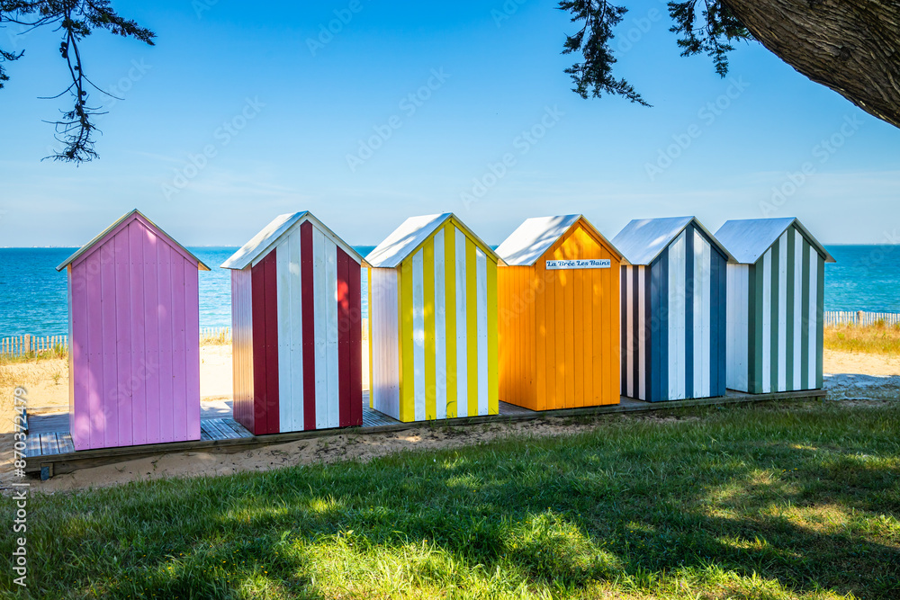 Naklejka premium Colored wooden beach huts of La Bree-les-Bains, France on a sunny day of summer