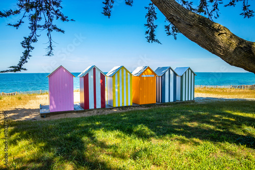 Colored wooden beach huts of La Bree-les-Bains, France