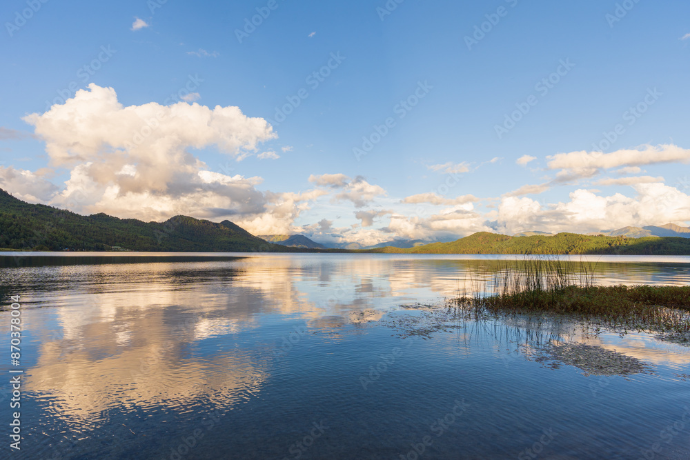 Fototapeta premium Beautiful freshwater lake view with cloudy blue-sky background—stunning view of the magical lake in the middle of the Himalayas.