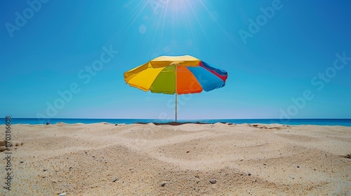 Vibrant Beach Umbrella Shadow on Sandy Shore Under Blue Skies - Wide Angle Canon EOS-1D X Mark III Shot