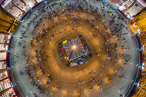 People dance at hindu Navratri festival the traditional Garba dance wearing indian clothes. Spectacular Top down aerial view of indian religious festival photo