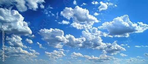 Clouds in a picturesque blue sky provide a scenic backdrop appropriate for a copy space image. photo