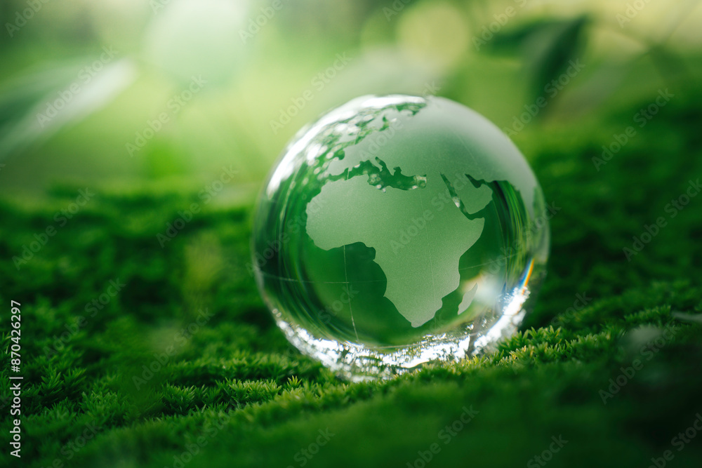 Crystal globe glass on green moss in forest to protect nature Save and care World for sustainable. concept of the environment ecology and Earth Day. eco environment and ESG concept.. Crystal globe glass on green moss in forest to protect nature Save and care World for sustainable. concept of the environment ecology and Earth Day. eco environment and ESG concept..