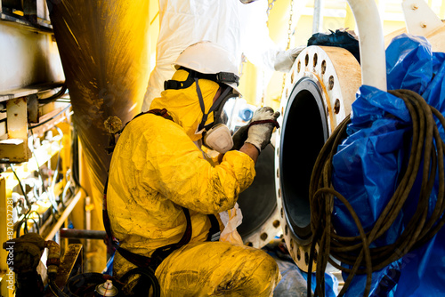 Employees inspect by taking photographs of internal pressure tanks in confined spaces.
