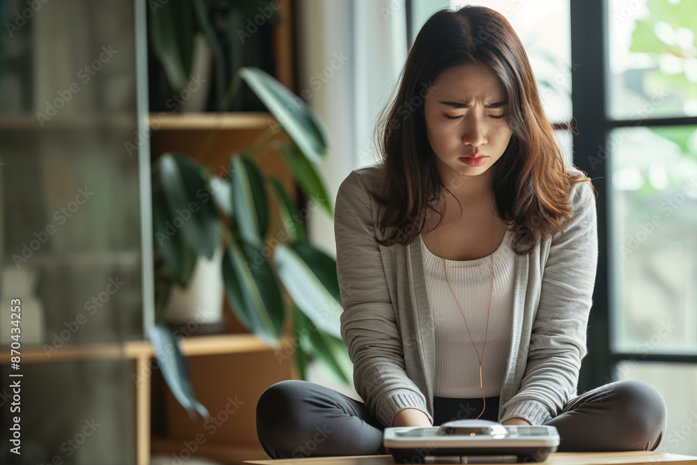 Sad woman with fat upset bored of dieting Weight loss fail Fat diet and scale sad asian woman on weight scale at home weight control Sad woman with fat upset bored of dieting Weight loss fail Fat diet and scale sad asian woman on weight scale at home weight control