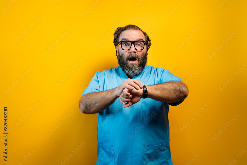 The doctor wearing a blue coat on a yellow background and looking at the clock. The doctor wearing a blue coat on a yellow background and looking at the clock.