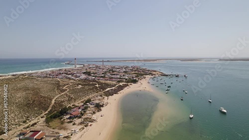 Wallpaper Mural Aerial of Farol Island in Algarve, Portugal, with sandy beaches, boats, and coastal village. Torontodigital.ca