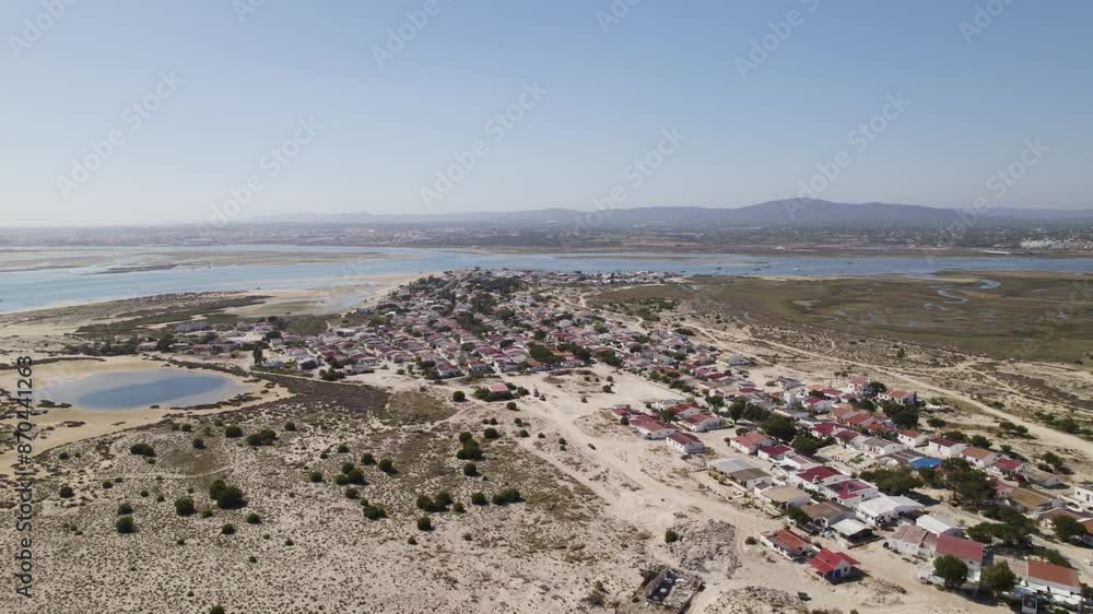 Aerial of Armona Island in Olhão, Algarve Portugal, featuring a coastal village and scenic wetlands. Aerial of Armona Island in Olhão, Algarve Portugal, featuring a coastal village and scenic wetlands.