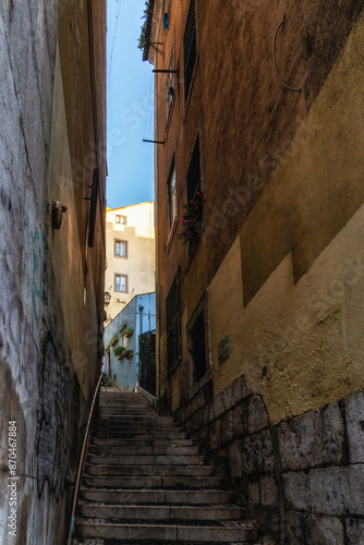 View of steep narrow Lisbon streets at medieval quarter Alfama