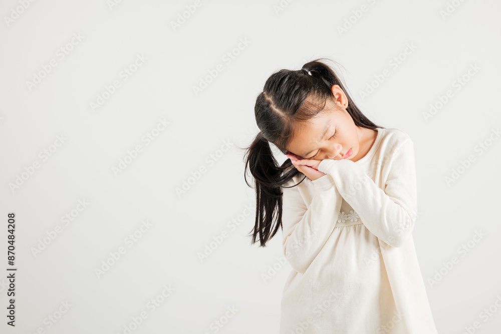 Portrait Asian young kid girl pretends emotions sleeping tired eyes closed dreaming with hands together near face, studio shot on white background, copy space, insomnia concept, kindergarten child Portrait Asian young kid girl pretends emotions sleeping tired eyes closed dreaming with hands together near face, studio shot on white background, copy space, insomnia concept, kindergarten child
