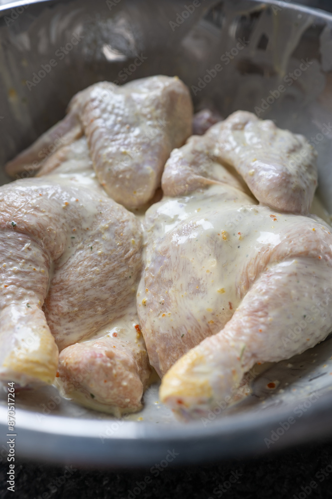 Homemade marinated chicken inside metal bowl Homemade marinated chicken inside metal bowl
