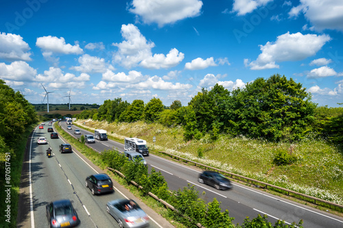 heavy traffic moving at speed on UK motorway in England at sunset photo