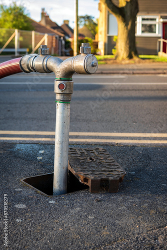 Fire hydrant connection point to supply water on road in england uk photo