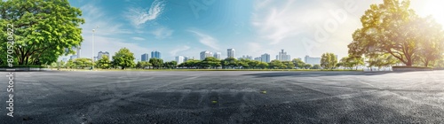 A wide-angle view of an empty asphalt road with the cityscape