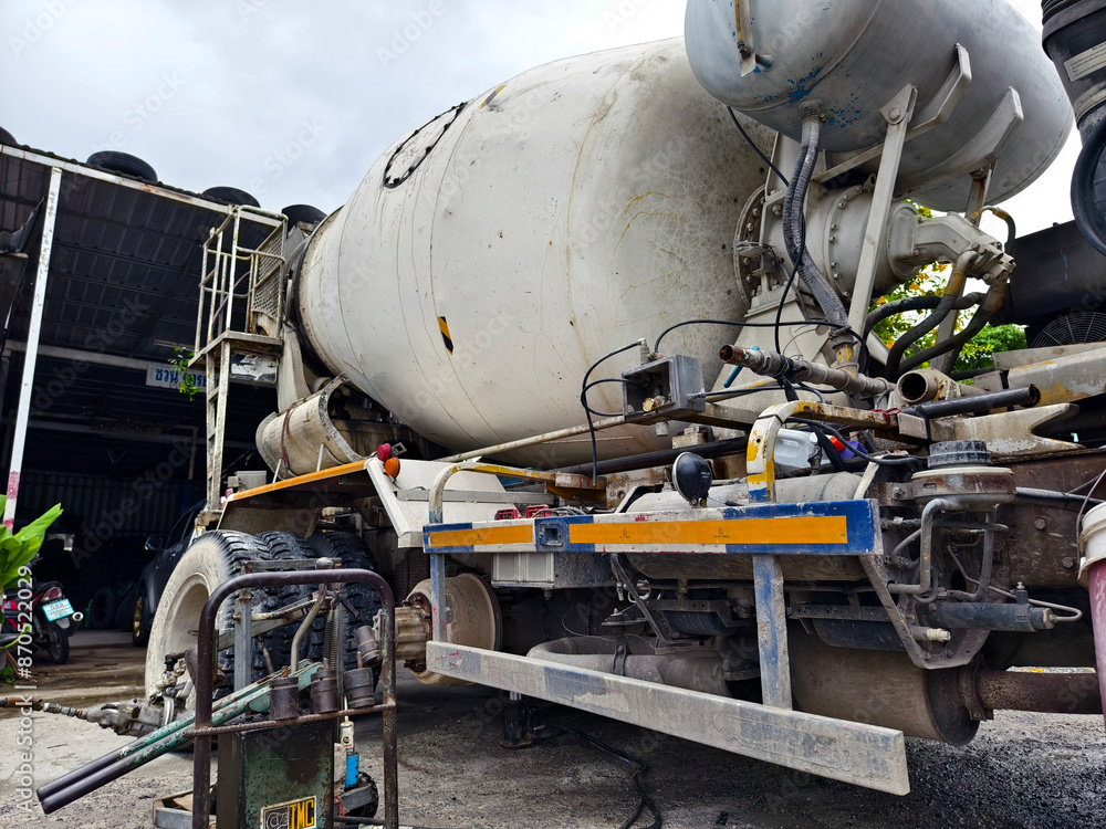 A concrete mixer truck parked beside of a concrete factory A concrete mixer truck parked beside of a concrete factory