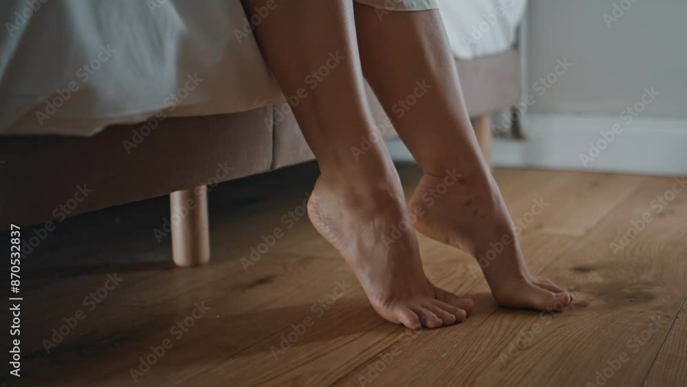 Closeup woman feet stepping at bed in softly lit bedroom. Calm person waking up Closeup woman feet stepping at bed in softly lit bedroom. Calm person waking up