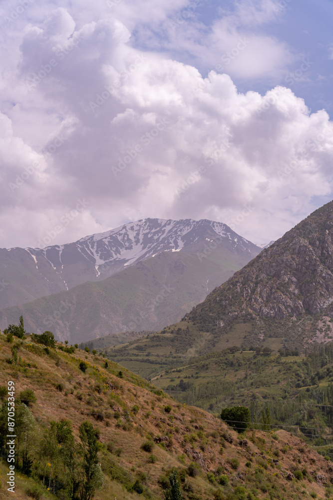 The sky is cloudy and the mountains are covered in snow The sky is cloudy and the mountains are covered in snow