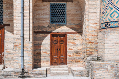 Uzbek carved wooden door to Kukeldash Madrasah with a traditional pattern decorated with oriental islamic ornaments in Uzbekistan in Tashkent photo