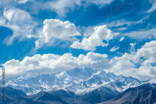 "Majestic Sierra Nevada: Snow-Capped Mountains and Cloudy Blue Skies"