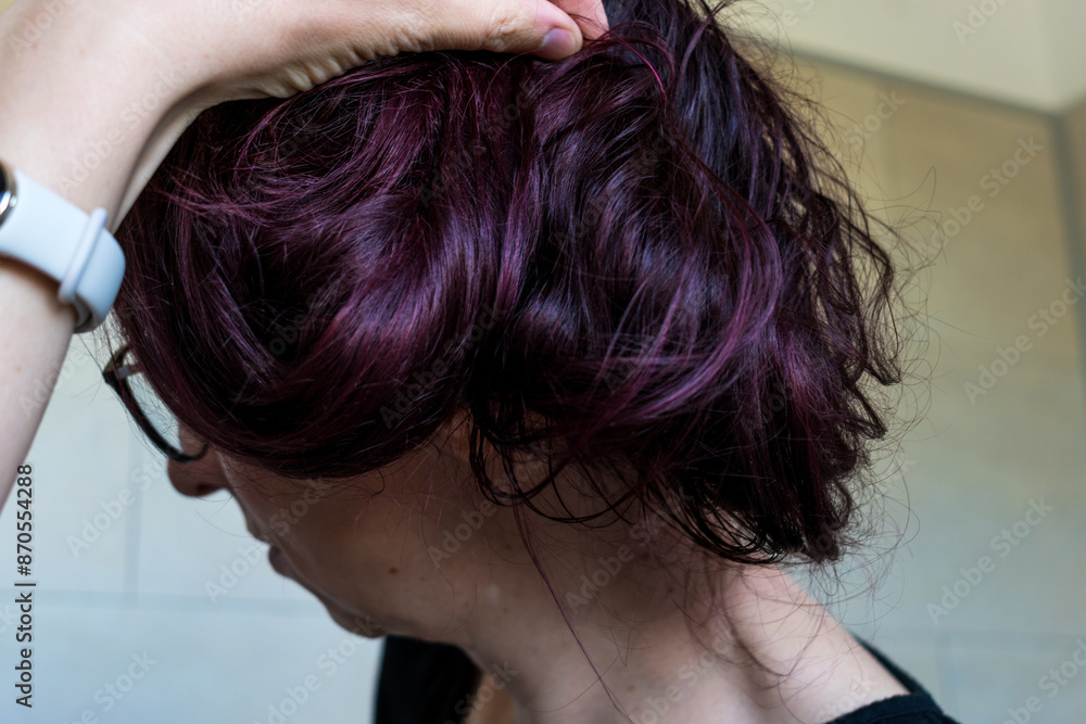 Woman with dark red hair, treatment with natural pigments based on blackberries and cherries Woman with dark red hair, treatment with natural pigments based on blackberries and cherries