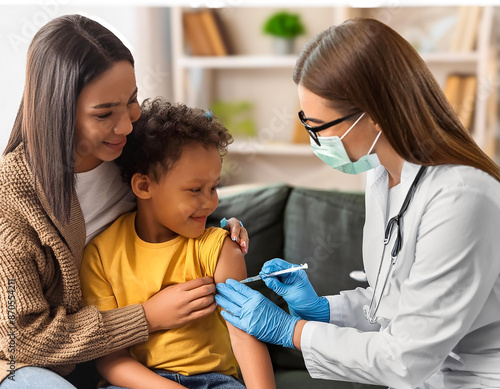 Little boy being vaccinated by female doctor at home