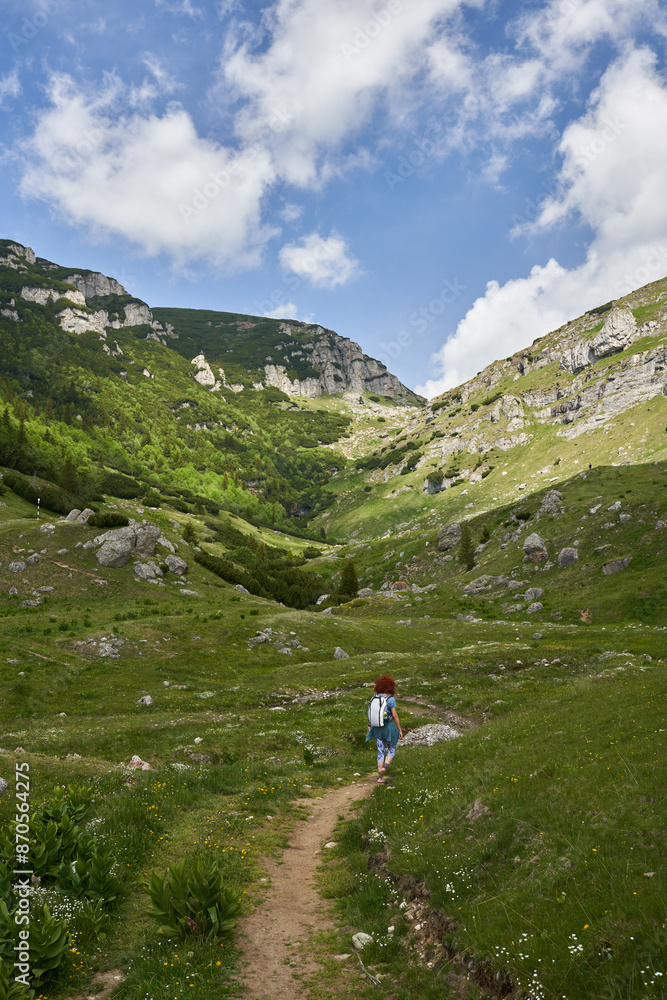 Hiker lady in the mountains on a trail Hiker lady in the mountains on a trail