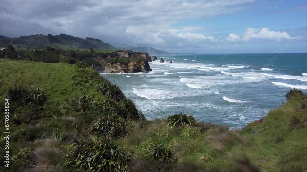 Drone view of the coast, rocks and ocean on a sunny summer day at Three Sisters and Elephant Rock, New Zealand. Drone view of the coast, rocks and ocean on a sunny summer day at Three Sisters and Elephant Rock, New Zealand.
