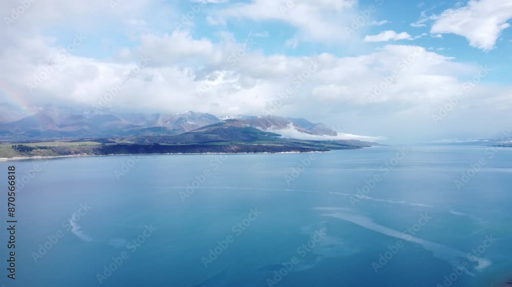 Drone view of blue Lake Pukaki and mountains on a sunny summer day in New Zealand. Drone view of blue Lake Pukaki and mountains on a sunny summer day in New Zealand.