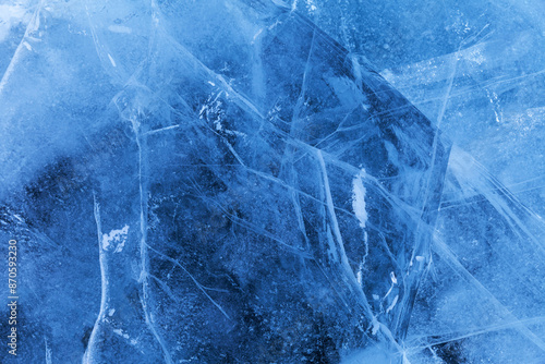 Beautiful crystalline ice texture. Cold background of blue ice with cracks and lines of icy surface of frozen Baikal Lake on winter. Unique ice pattern. Top view, flat lay, mockup, copy space