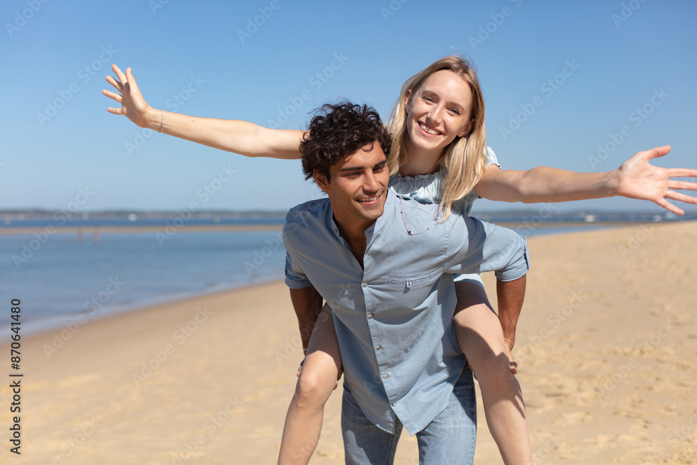 joyful girl piggybacking on boyfriend having fun joyful girl piggybacking on boyfriend having fun