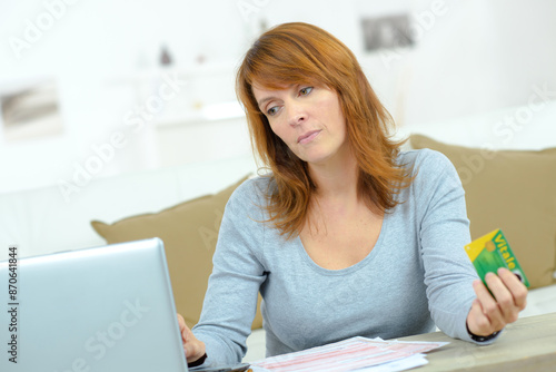 a woman holds a healthcard photo