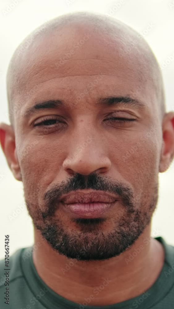 Close-up portrait of calm mindful athletic man with eyes closed on the blurred background of the sea Close-up portrait of calm mindful athletic man with eyes closed on the blurred background of the sea