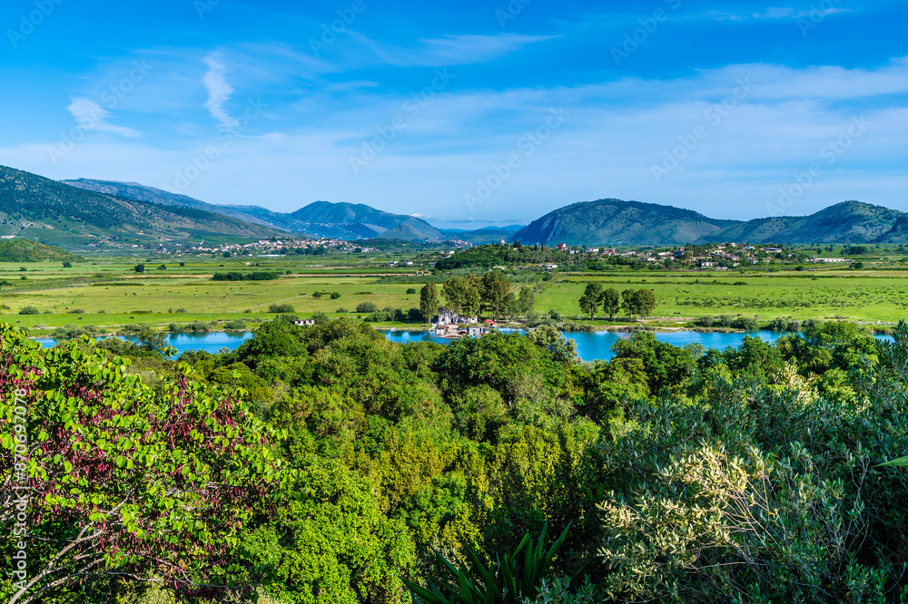 A view towards settlements across the Corfu Strait from the castle in the ancient ruins at Butrint, Albania in summertime A view towards settlements across the Corfu Strait from the castle in the ancient ruins at Butrint, Albania in summertime