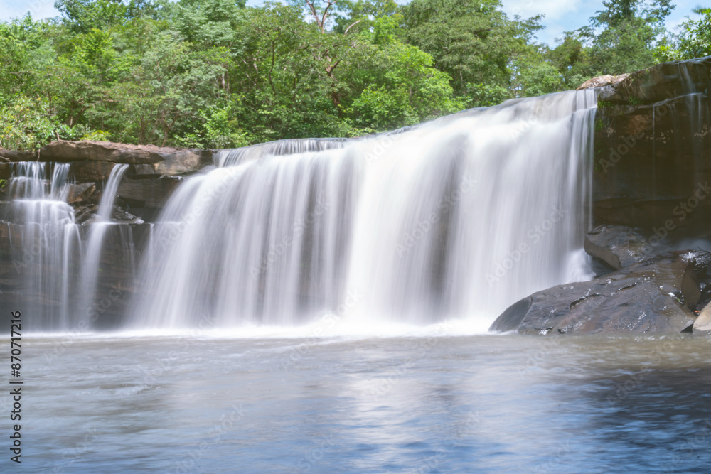 Obraz premium The source of the river in the forest. waterfall with forest in the background.Lake waterfall , Mountains trees Nature.The beautiful peguche waterfall flowing.