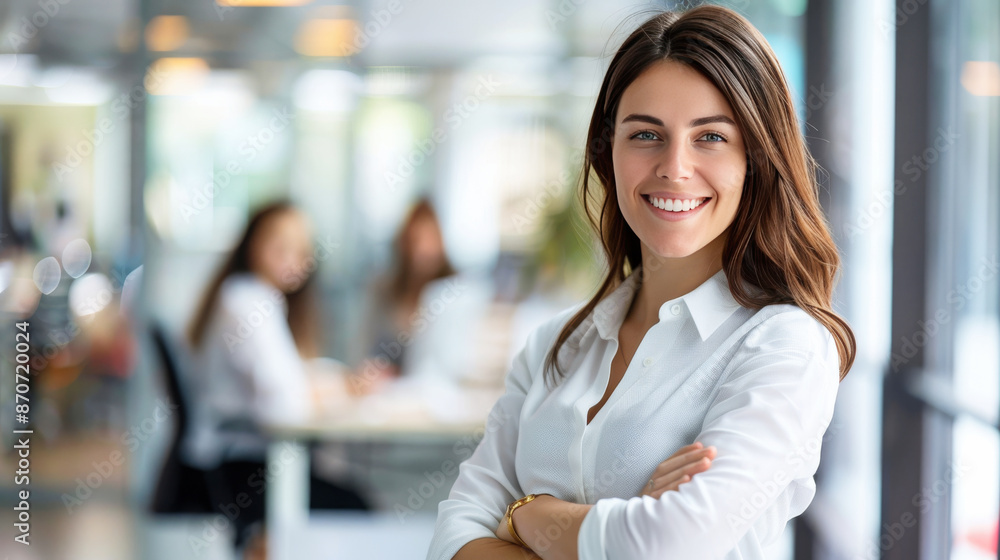 Fototapeta premium A confident professional young business woman standing in her office