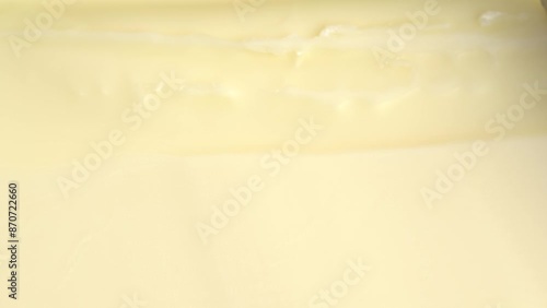 Cutting the fresh butter with knife, macro shot. Putting knife into butter, close up.