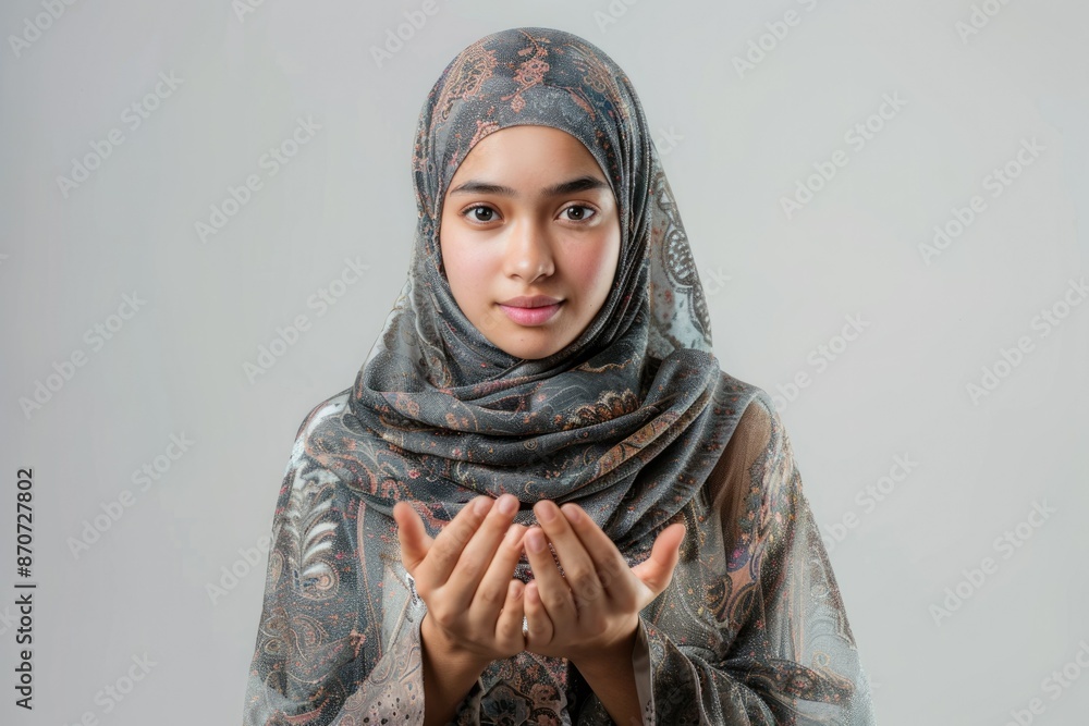 Asian Muslim woman in hijab gesturing Eid Mubarak greeting. Asian Muslim woman in hijab gesturing Eid Mubarak greeting.