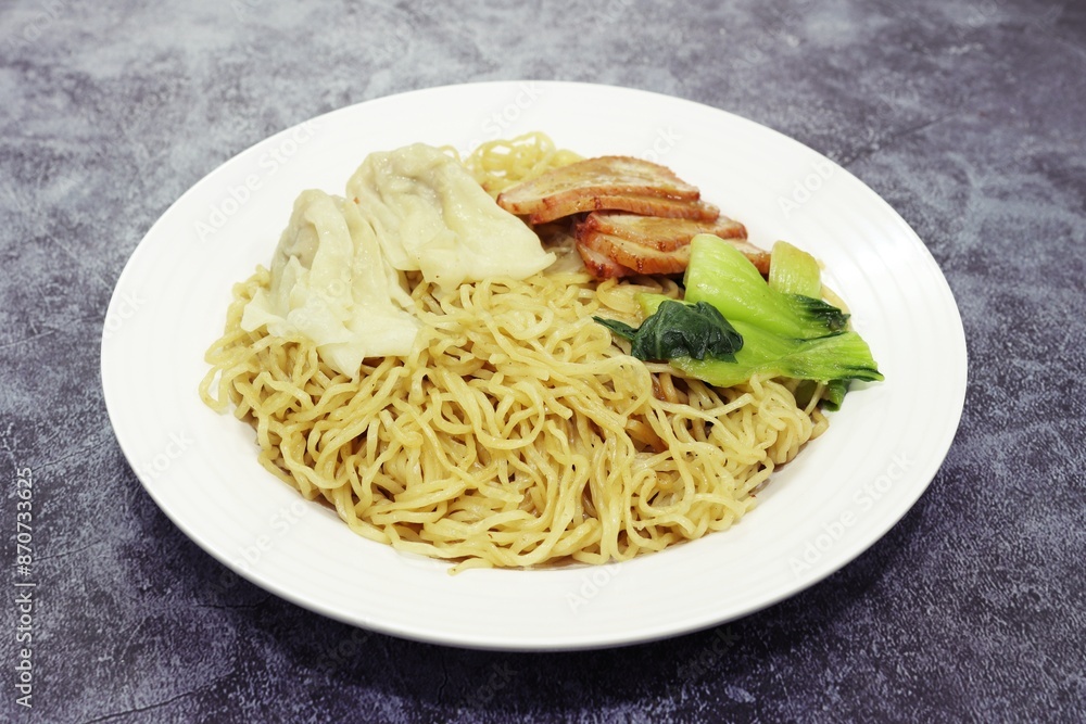 Egg Noodle with Pork Wonton and BBQ Pork in white plate, close up photo high angle view Egg Noodle with Pork Wonton and BBQ Pork in white plate, close up photo high angle view