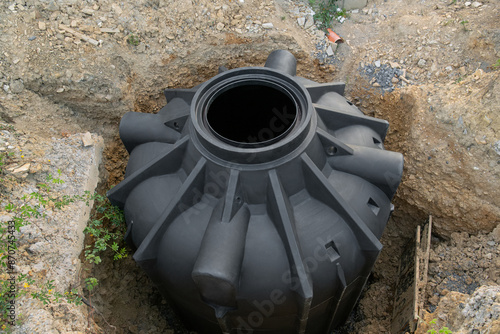 New septic tank for collecting rainwater or separate sewage. container underground on the construction site of a private house.