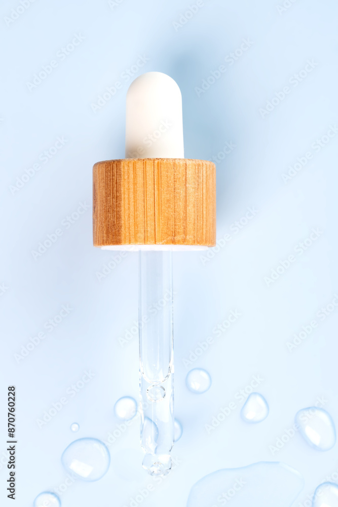 Close-up of a pipette with a hyaluronic moisturizing serum on a blue background. Beauty skin care concept research. Beauty and spa. Close-up of a pipette with a hyaluronic moisturizing serum on a blue background. Beauty skin care concept research. Beauty and spa.