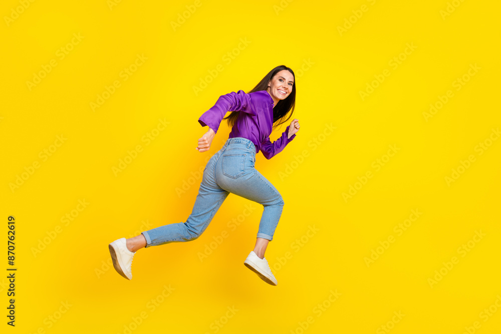 Profile side photo of positive lady run fast jump isolated bright color background Profile side photo of positive lady run fast jump isolated bright color background