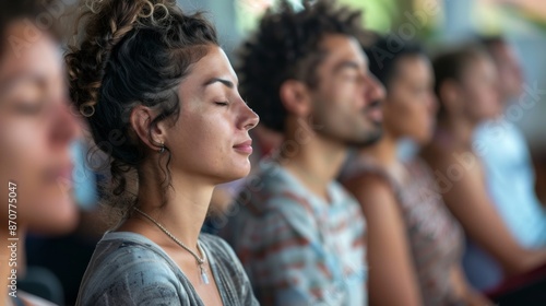 A group of people participate in a wellness retreat workshop, practicing mindfulness through meditation