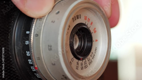 Fingers Delicately Adjust Focus Ring on Vintage Film Camera